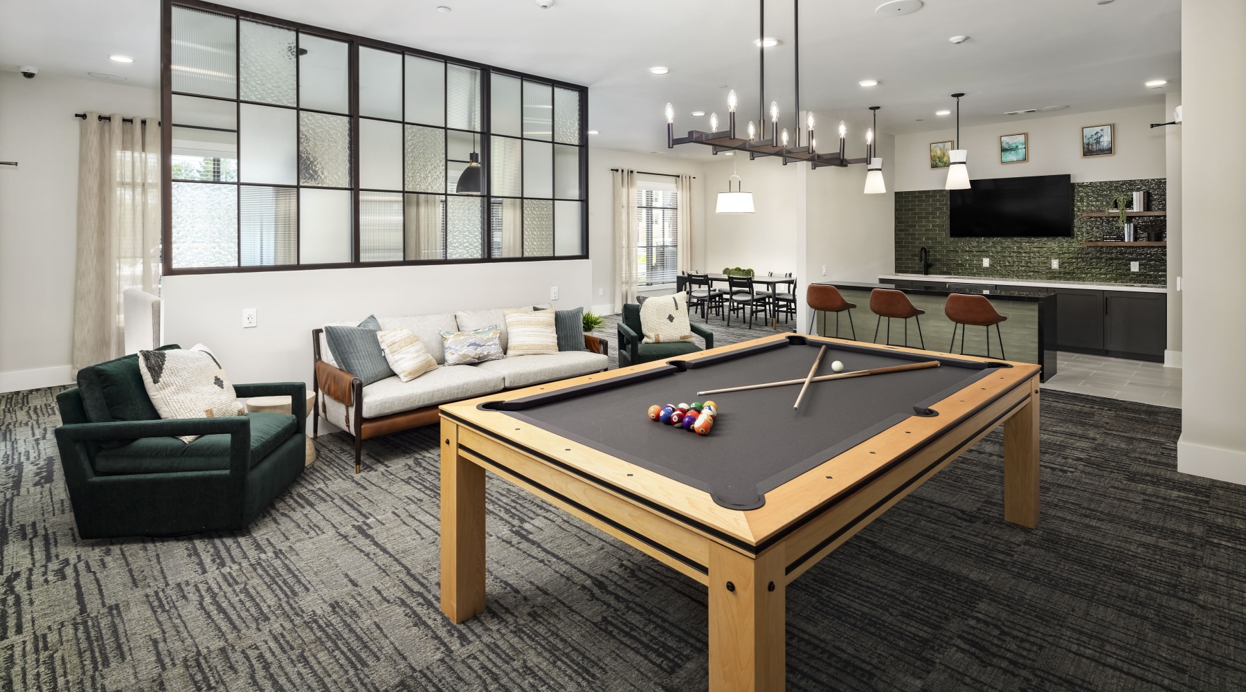 Modern resident lounge with pool table, TV, and gathering spaces at Arcadia at Symphony Park McDonough apartments Modern resident lounge with pool table, TV, and gathering spaces at Arcadia at Symphony Park McDonough apartments