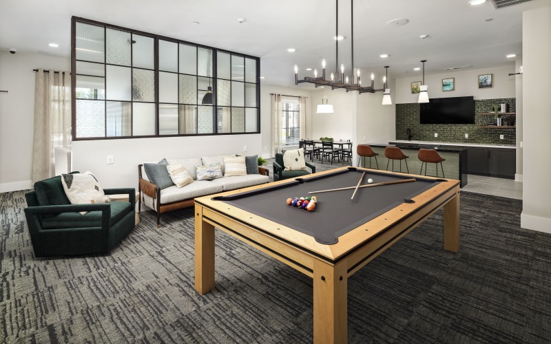 Modern resident lounge with pool table, TV, and gathering spaces at Arcadia at Symphony Park McDonough apartments