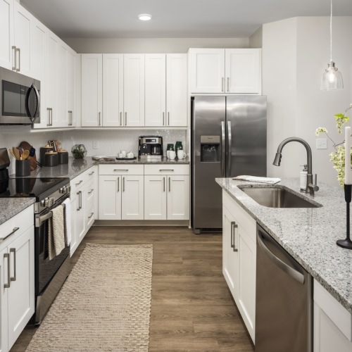 Kitchen with light cabinets, granite countertops and island at Arcadia Symphony Park Apartments for rent in McDonough Kitchen with light cabinets, granite countertops and island at Arcadia Symphony Park Apartments for rent in McDonough